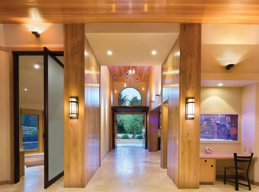 Varial LED Wall Sconces in oil rubbed bronze illuminating a hacienda-style home interior with wooden walls and ceilings